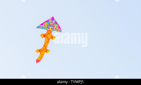 Colorful kite flying in blue sky Stock Photo