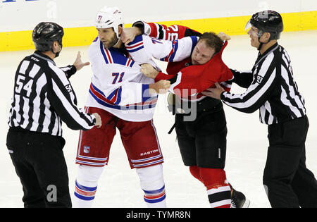 The New Jersey Devils' Mike Rupp knocks down a high puck against the ...