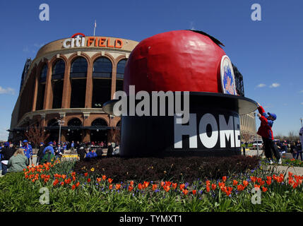 A fan leaps to touch the Mets Home Run Apple outside of the stadium before the New York Mets play the Atlanta Braves on Opening Day at Citi Field in New York City on April 5, 2012.   UPI/John Angelillo Stock Photo