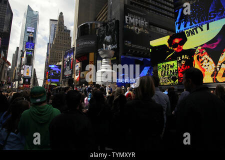 https://l450v.alamy.com/450v/tymxyr/nhl-fans-and-pedestrians-stand-around-a-21-foot-6600-pound-replica-of-the-stanley-cup-in-times-square-in-new-york-city-on-april-11-2012-the-stanley-cup-replica-also-serves-as-a-working-fountain-so-nhl-fans-can-drink-from-the-famous-trophy-upijohn-angelillo-tymxyr.jpg