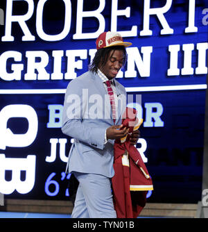 Baylor quarterback Robert Griffin III stands on the stage holding a  Redskins Jersey after the Washington Redskins select him as the #2 overall  pick in the 2012 NFL Draft at Radio City