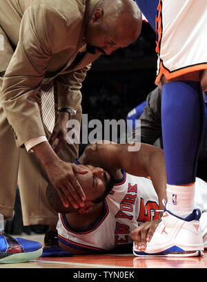 New York Knicks Carmelo Anthony rubs his eye in the fourth quarter against  the Miami Heat in the second quarter of game 3 of the Eastern Conference  first round of the 2012