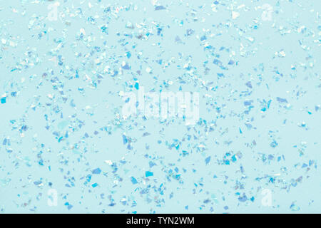 Blue glowing mica glitter on pastel blue trendy abstract background. Stock Photo