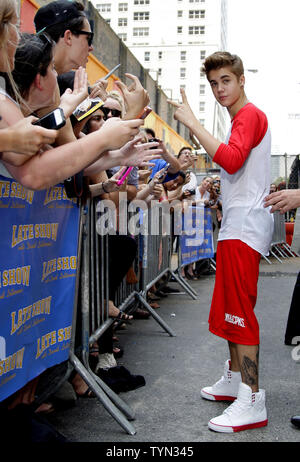 Justin Bieber meets fans outside of the Ed Sullivan Theater before appearing on the Late Show with David Letterman in New York City on June 20, 2012.       UPI/John Angelillo Stock Photo