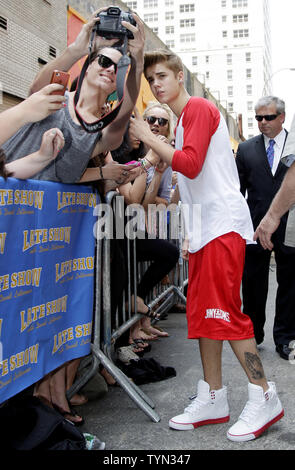 Justin Bieber meets fans outside of the Ed Sullivan Theater before appearing on the Late Show with David Letterman in New York City on June 20, 2012.       UPI/John Angelillo Stock Photo