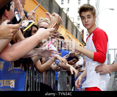 Justin Bieber meets fans outside of the Ed Sullivan Theater before appearing on the Late Show with David Letterman in New York City on June 20, 2012.       UPI/John Angelillo Stock Photo