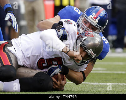 Entertainment reporter Maria Menounos, wearing a Tom Brady #12 New England  Patriots' jersey, tries to tackle New York Giants' Chase Blackburn at Media  Day for Super Bowl XLII at the University of