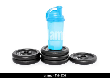 Protein shaker on a pedestal of weight plates, isolated on a white background. Look after your health and well being. Stock Photo