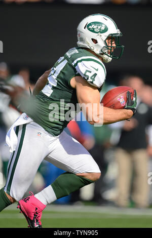 New York Jets linebacker Nick Bellore (54) gets a pass from Jets  quarterback Tim Tebow (not pictured) for 23 yard gain in the second quarter  against the Indianapolis Colts in week 6