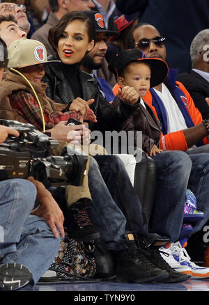 Alicia Keys, Swizz Beatz & Baby Egypt watch the New York Knicks play the Miami Heat in the first quarter in the Knicks Home opener at Madison Square Garden in New York City on November 2, 2012.     UPI/John Angelillo Stock Photo