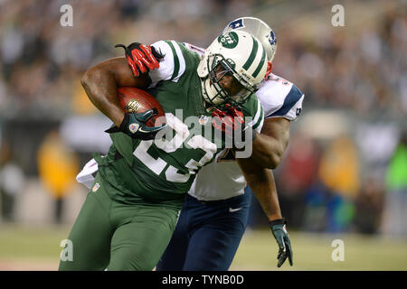 New York Jets running back Shonn Greene (23) carries the ball as New  England Patriots outside linebacker Jerod Mayo (51) defends in the first  quarter in week 12 of the NFL season