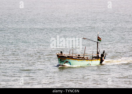 Diu, Daman, Gujarat, India - Circa 2019: Colorful open boat sailing in the blue sea of daman diu. The blue green hull and the open boat with its mast Stock Photo