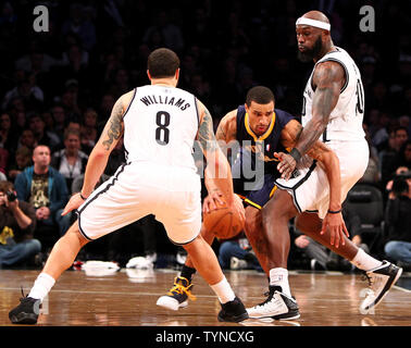 Brooklyn Nets guard Deron Williams (8) and Brooklyn Nets forward Reggie Evans (30) defend as Indiana Pacers guard George Hill (3) drives the ball in the fourth quarter at the Barclays Center in New York City on January 13, 2013.  Nets defeat Pacers 97-86.     UPI/Nicole Sweet Stock Photo