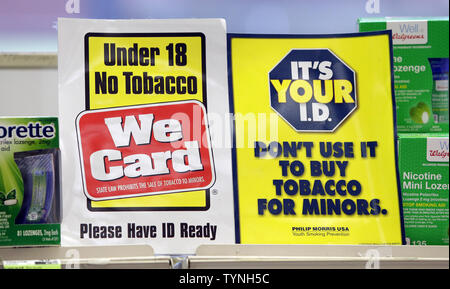 buy cigarettes at 18 A sign with the legal age to purchase cigarettes and tobacco products  stands behind the counter of a retail store in New York City on April 23,  2013. New York City Mayor