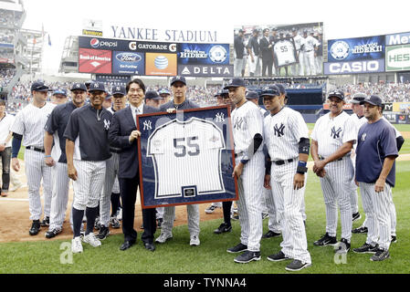Retired New York Yankees players Mariano Rivera watches Paul O'Neill and  his wife Nevalee unveil a plaque at a ceremony inducting O'Neill into  Monument Park before the game against the Cleveland Indians