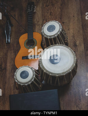 Acoustic guitar, cajon and tabla - view of the musical instruments used for fusion eastern and western music, and also jazz and blues. Stock Photo