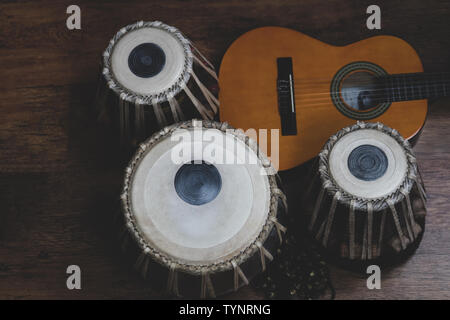 Acoustic guitar, cajon and tabla - view of the musical instruments used for fusion eastern and western music, and also jazz and blues. Stock Photo