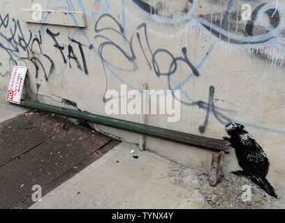 An art work created by British street artist Banksy is seen in New York City on October 10, 2013. Banksy is a pseudonymous England-based graffiti artist, political activist, film director, and painter. His satirical street art and subversive epigrams combine dark humor with graffiti done in a distinctive stenciling technique.    UPI/Dennis Van Tine Stock Photo