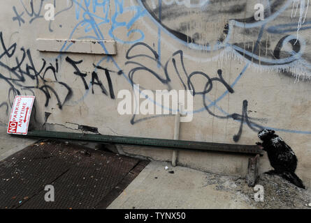 An art work created by British street artist Banksy is seen in New York City on October 10, 2013. Banksy is a pseudonymous England-based graffiti artist, political activist, film director, and painter. His satirical street art and subversive epigrams combine dark humor with graffiti done in a distinctive stenciling technique.    UPI/Dennis Van Tine Stock Photo