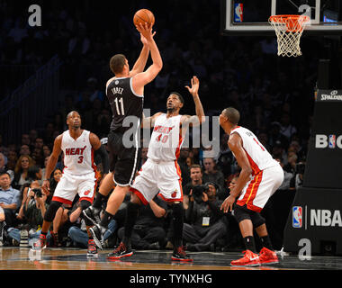 Brooklyn Nets center Brook Lopez (11) shoots over Miami Heat power forward Udonis Haslem (40), Heat shooting guard Dwyane Wade (3) and Heat center Chris Bosh (1) in the first quarter at Barclays Center in New York City on November 1, 2013.   UPI/Rich Kane Stock Photo