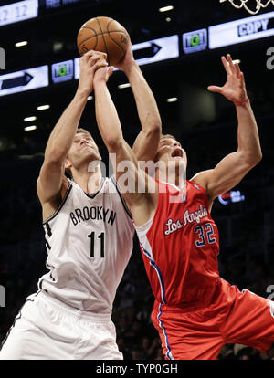 Brooklyn Nets Brook Lopez and Los Angeles Clippers Blake Griffin reach for a rebound in the first half at Barclays Center in New York City on December 12, 2013.     UPI/John Angelillo Stock Photo