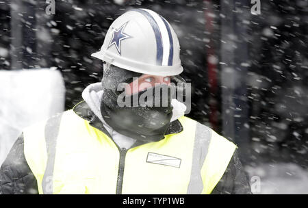 A construction worker wears a dallas cowboy hard hat while working in the  snow in Times Square 12 days before Super Bowl XLVIII in New York City on  January 21, 2014. New