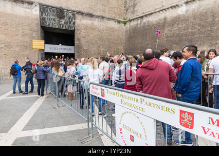 ROME, ITALY - APRIL 23, 2019:  Crowds of tourists wait at the entrance to Vatican Museums (Musei Vaticani). Concept for overtourism and mass-tourism. Stock Photo