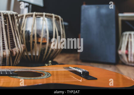 Acoustic guitar, cajon and tabla - view of the musical instruments used for fusion eastern and western music, and also jazz and blues. Stock Photo