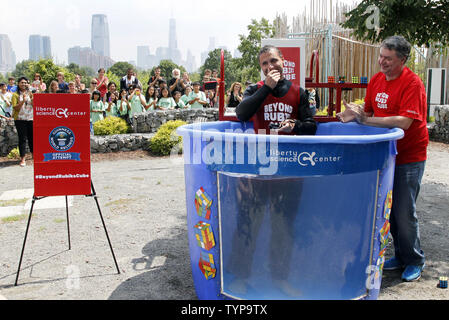 North American Speed Cube Champion Anthony Brooks smiles as he emerges from a water tank after he breaks the Guinness Record for most Rubik's Cube puzzles solved underwater in one breath at National Rubik's Cube Championship at Liberty Science Center in Jersey City, NJ on August 1, 2014. Brooks set a new record solving 5 cubes in 1:18 beating the old record of record 4 cubes solved in 1:30. UPI/John Angelillo Stock Photo
