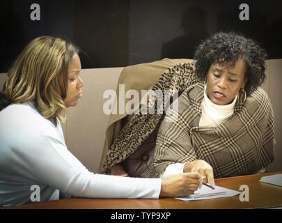 Mrs. Natasha Whitfield (left), PhD., a clinical psychologist with the Substance Abuse Treatment Program of the Atlanta Veterans Affairs Medical Center discusses substance abuse treatment concerns with Ms. Wyuca D. Bradham, an alcohol and drug control officer assigned to the 3rd Medical Command (Deployment Support), during a Substance Abuse Action Meeting at the 335th Signal Command (Theater) headquarters Nov. 21.  The meeting, which was attended by Soldiers and civilians, provided attendees with an opportunity for two-way communication and consultation with subject matter experts. Stock Photo