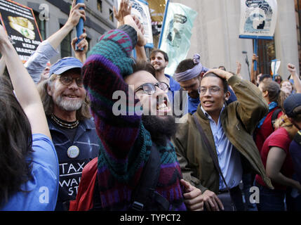 Protesters block traffic on lower Broadway near Wall Street during a rally and protest called 'Flood Wall Street' in New York City on September 22, 2014.  The protest was similar to the Occupy Wall Street set of protests but this one was more related to Climate Week and Global Warming Issues.   UPI/John Angelillo Stock Photo