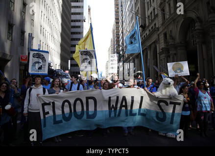 Protesters block traffic on lower Broadway near Wall Street during a rally and protest called 'Flood Wall Street' in New York City on September 22, 2014.  The protest was similar to the Occupy Wall Street set of protests but this one was more related to Climate Week and Global Warming Issues.   UPI/John Angelillo Stock Photo