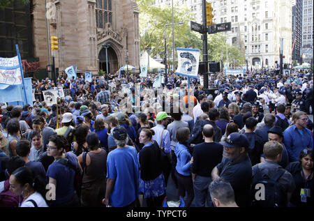 Protesters block traffic on lower Broadway near Wall Street during a rally and protest called 'Flood Wall Street' in New York City on September 22, 2014.  The protest was similar to the Occupy Wall Street set of protests but this one was more related to Climate Week and Global Warming Issues.   UPI/John Angelillo Stock Photo