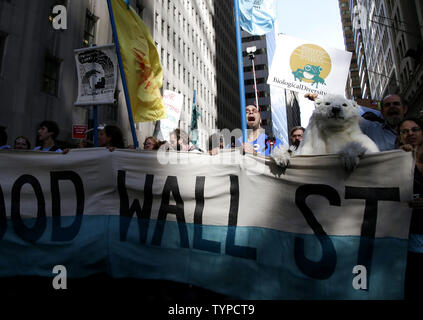 Protesters block traffic on lower Broadway near Wall Street during a rally and protest called 'Flood Wall Street' in New York City on September 22, 2014.  The protest was similar to the Occupy Wall Street set of protests but this one was more related to Climate Week and Global Warming Issues.   UPI/John Angelillo Stock Photo