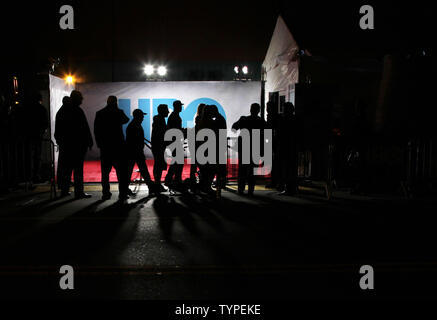 People walk by the HBO logo at New York Premiere of HBO's 'Olive Kitteridge' at SVA Theater in New York City on October 27, 2014. Olive Kitteridge is a novel by American author Elizabeth Strout.  UPI/John Angelillo Stock Photo