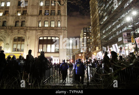 Two separate protests, both for and against police, are kept separate by the NYPD outside of City Hall in lower Manhattan over 2 weeks after a decision by a grand jury not to indict an NYPD officer involved in the apparent chokehold death of Eric Garner in New York City on December 19, 2014.  Demonstrators gathered at City Hall in support of the NYPD Friday evening, but they were met right away with a rival demonstration by critics of police policies. Garner, a 43 year old father of six, died in July after police officers attempted to arrest him for allegedly selling loose, untaxed cigarettes Stock Photo