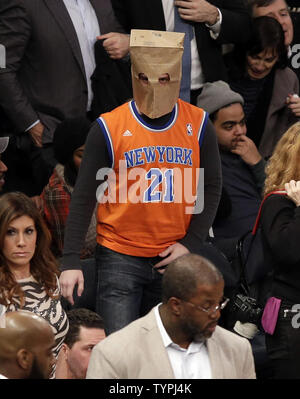 A Detroit Lions fan wears a paper bag over his head during a game