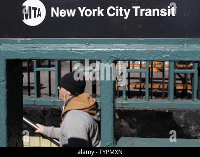 A man climbs the stairs exiting the subway on Houston Street in New York City on March 23, 2015. Commuters faced higher prices Monday morning after MTA fares went up over the weekend on subways, buses and commuter rails as well as at toll booths. Fare increases kicked in Sunday as part of a series of increases in recent years built into the cash-strapped MTA's budget.    Photo by John Angelillo/UPI Stock Photo