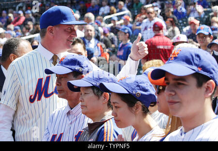 Matt Harvey, David Wright, Curtis Granderson from the Mets stand with  Justin and Jaden Ramos who join their mother Maritza Ramos and the family  of Wenjian Liu when they throw out the