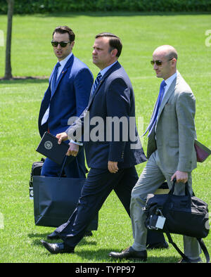 Washington, District of Columbia, USA. 26th June, 2019. From left to right: Deputy Assistant to the President for Operations and Personal Aide to the President Nicholas Luna, White House Director of Social Media Dan Scavino, Senior Advisor for Policy Stephen Miller follow United States President Donald J. Trump as he departs the South Lawn of the White House in Washington, DC en route to the G20 summit in Osaka, Japan on Wednesday, June 26, 2019 Credit: Ron Sachs/CNP/ZUMA Wire/Alamy Live News Stock Photo
