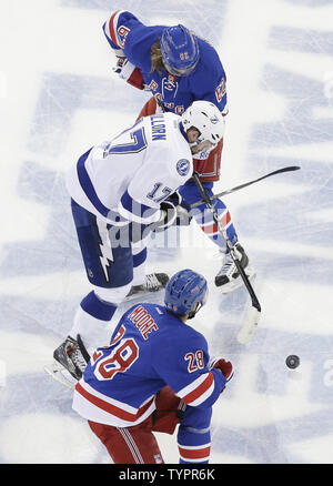 Tampa Bay Lightning Alex Killorn skates between New York Rangers Dominic Moore and Carl Hagelin in the first period in game 2 in the third round of the Stanley Cup Playoffs at Madison Square Garden in New York City on May 18, 2015.         Photo by John Angelillo/UPI Stock Photo