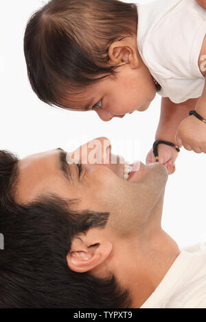 Man carrying his son and smiling