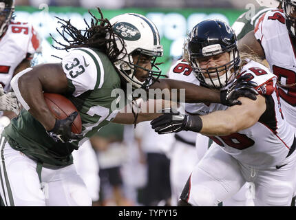 New York Jets Chris Ivory 33 runs downfield as the Carolina Panthers Quintin Mikell 27 gives chase during the second half of an NFL football game in Charlotte N.C. Sunday Dec. 15