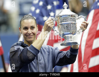 Flavia Pennetta of Italy holds the championship Trophy after her straight sets victory over Roberta Vinci of Italy in the Women's Final in Arthur Ashe Stadium at the US Open Tennis Championships at the USTA Billie Jean King National Tennis Center in New York City on September 12, 2015. Pennetta wins the match 7-6, 6-2 becoming the first Italian women to win a US Open and also announced her retirement at the Trophy Ceremony.     Photo by John Angelillo/UPI Stock Photo