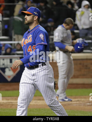 New York Mets relief Jonathon Niese (49) walks off the field after striking out Chicago Cubs batter Anthony Rizzo (rear) to end the sixth inning of game 2 of the NLCS at Citi Field in New York City on October 18, 2015.    Photo by Ray Stubblebine/UPI Stock Photo