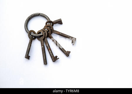 Bunch of different keys on a white background. New housing, property and mortgage loan concept. Copy space Stock Photo
