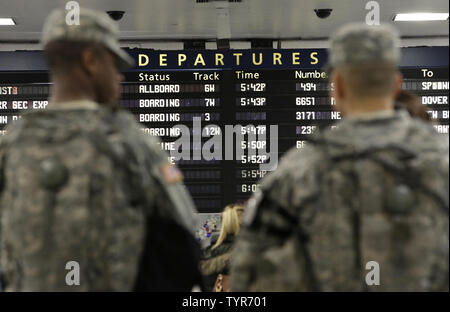 Two U.S. Army National Guard men stand guard among travelers at Penn Station on December 22, 2015 in New York City. Security is still high at landmarks and tourist areas around Manhattan since the November Paris terrorist attacks that killed over 100 people.    Photo by John Angelillo/UPI Stock Photo