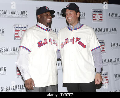 Ken Griffey Jr. and New York Mets Mike Piazza stand on the stage