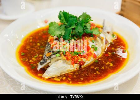 A plate of chopped pepper fish head taken in the restaurant. Stock Photo