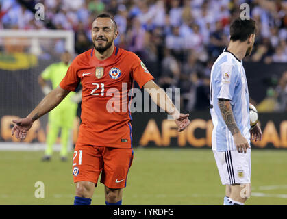 Chile midfielder Marcelo Diaz (21) reacts after he drew a second yellow card when he fouled Argentina's Lionel Messi (right), and is ejected from the game as a result, in the first half at the Copa America Centenario USA 2016 Finals at MetLife Stadium in East Rutherford, New Jersey, on June 26, 2016.   Photo by Ray Stubblebine/UPI Stock Photo